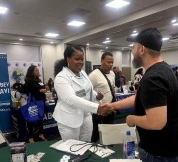 Sharna Barnes shaking hands at a business event